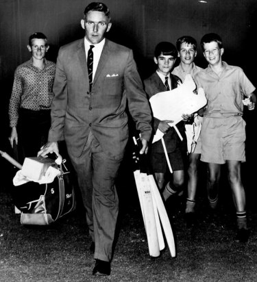 Alan Davidson leaves the SCG after a game in 1963, followed by some young fans.