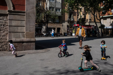 Children play at Plaça de la Vila de Gracia on April 26, 2020 in Barcelona, Spain.