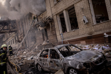 Firefighters work to extinguish a fire at a shopping centre and surrounding buildings after a Russian missile strike in Kharkiv, Ukraine. 