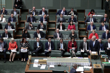 Female Liberal MPs wear red in a show of solidarity in the House of Representatives on Monday. 