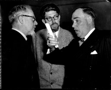 “It’s the natural thing.” Artists Douglas Dundas (left) and Weaver Hawkins listen while Governor Sir John Northcott expounds a point on September 25, 1953.