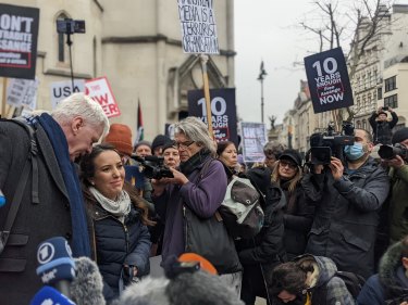 Kristinn Hrafnsson from WikiLeaks speaks with Stella Moris, fiancée of Julian Assange, outside the Royal Courts of Justice in London on Monday, 24 January 2022 in front of supporters holding signs that claimed “Mainstream Media is a Terrorist Organisation.”