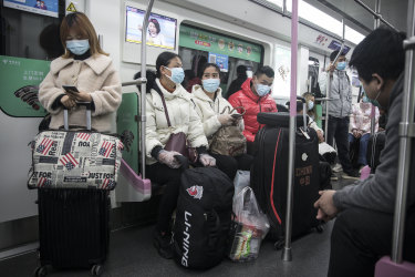 Passengers on a train on March 28, 2020 in Wuhan, Hubei Province, China. Services are gradually resuming after the lockdown imposed to try and contain the disease where it originated, possibly from a wet market where wild animals are traded and slaughtered.