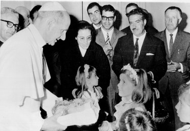 Pope Paul VI receives a box of peaches from children at his summer residence July 28th on the occasion of the Castel Gandolfo festival of Peaches. The Pontiff July 29th overruled Roman Catholic liberals and condemned the pill and all other artificial means of birth control. July 29, 1968.
