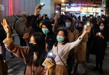 People raise their cellphones lights as they form a human chain on New Year's eve in Hong Kong.