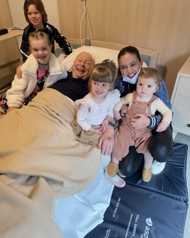 Bert Newton surrounded by his grandchildren in hospital.