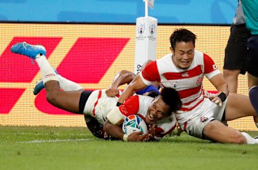 Jubilant Japan celebrate after scoring another try. 