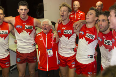 Close shave: Sydney players belt out the song after their five-point win over Essendon.