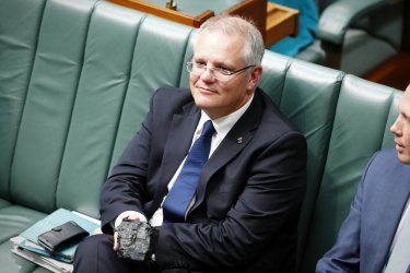 “Don’t be afraid”: Prime Minister Scott Morrison holding a  lump of coal during question time in 2017 when he was Treasurer.