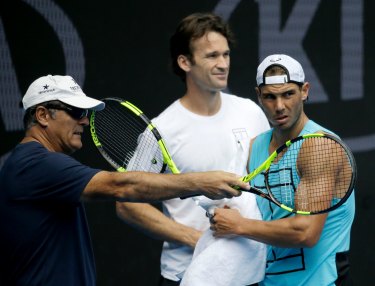 Carlos Moya (middle) working with Rafael Nadal (right) in 2017.