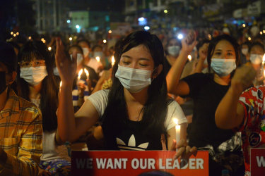 Protesters attend a candlelight night rally in Yangon on Saturday night. 