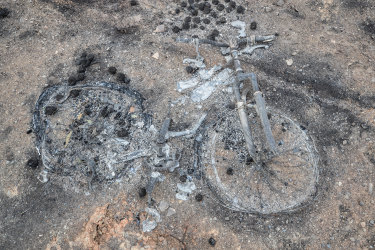 Nothing but blackened wires and charred metal is all that remains of this bicycle.