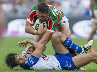 Absorbing battle: Bulldogs half Lachlan Lewis locks horns with Souths skipper Sam Burgess.