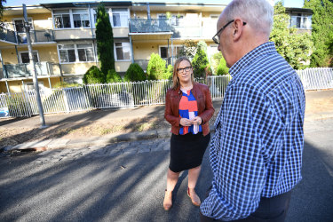 Les in front of his former North Melbourne home, with Inner Melbourne Community Legal lawyer Molly Williams, from Inner Melbourne Community Legal.