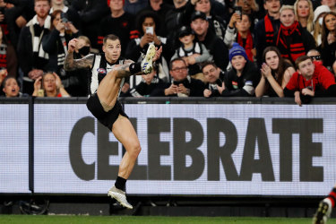 Miracle man: Jamie Elliott boots the match winner against Essendon, giving the Magpies a ninth-straight win.