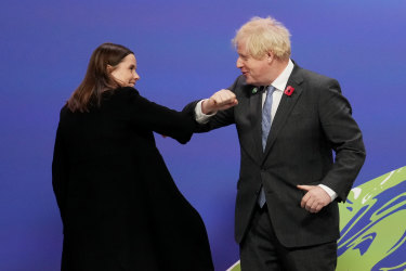 British Prime Minister Boris Johnson (R) greets Iceland Prime Minister Katrín Jakobsdóttir as they arrive for day two of COP26 in Glasgow, Scotland. 