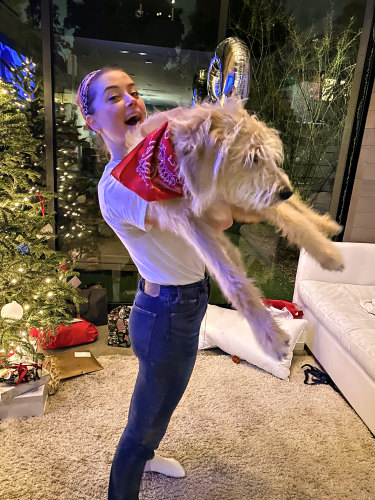 Actress Amber Heard displays her new dog named Barnaby Joyce. 