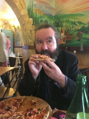 Brendan Foster enjoying a Pear Tree pizza.