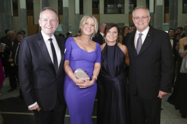 Opposition Leader Bill Shorten and Chloe Shorten with Prime Minister Scott Morrison and Jenny Morrison as they arrive for the Mid Winter Ball at Parliament House in Canberra Wednesday night.