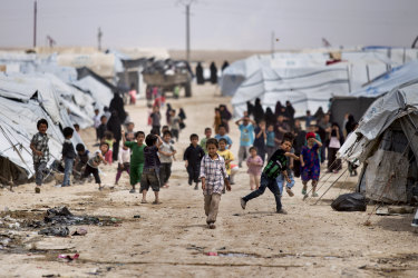 Children gather outside their tents, at al-Hawl camp, which houses families of members of the Islamic State group, in Hasaka province, Syria.