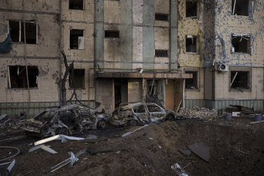 Ukrayna'nın Kiev kentinde Pazar günü meydana gelen bombalı saldırının ardından ağır hasarlı bir konut binasının önünde bir krater görüldü.