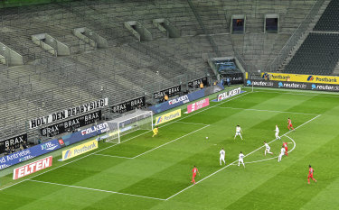 German footballers play in a stadium with no specators.