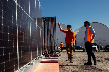 5B staffer Victor Rego (left) shows new head of product development Lloyd Niccol a set of the firmâ€™s pre-fabricated solar modules in Kurnell, Sydney. 