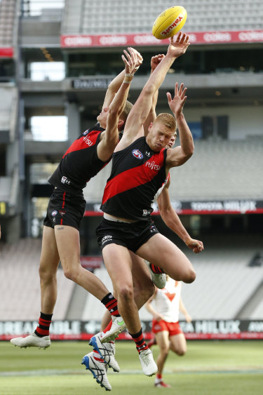 Nik Cox and Peter Wright fly for Essendon.