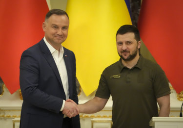 Ukrainian President Volodymyr Zelensky and Polish President Andrzej Duda shake hands during a news conference after their meeting in Kyiv, Ukraine.