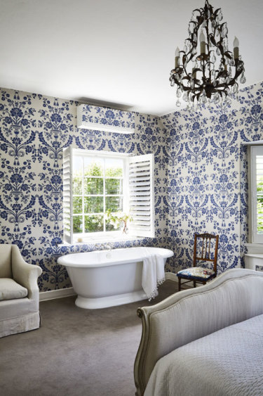 “Our bedroom bath is very conducive to daydreaming,” says Penelope. The bath is from The English Tapware Company and the wallpaper is by Farrow & Ball.