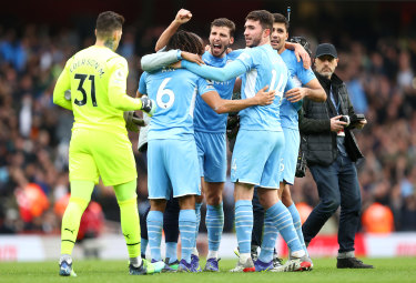 Manchester City players celebrate at full time after the Premier League match against Arsenal.