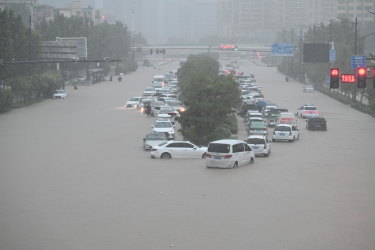 Vehicles are stranded in floodwater near Zhengzhou Railway Station in central Chinaâ€™s Henan province.