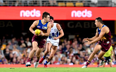 Jarryd Lyons of the Lions breaks away from the defence during the round three AFL match between the Brisbane Lions and the North Melbourne Kangaroos.