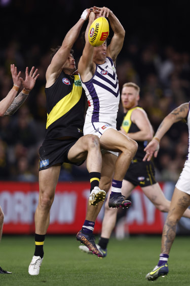 Robbie Tarrant and Bailey Banfield leap for the ball.