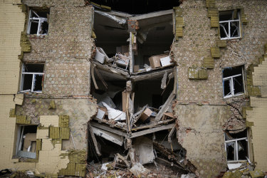 Debris hangs from a residential building heavily damaged in a Russian bombing in Bakhmut, eastern Ukraine, on Saturday.