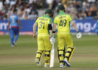 David Warner chats to Australia's Steve Smith during the match. 