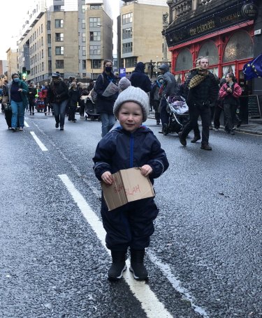 Little boy at the COP26 protests in Glasgow with a placard quoting Greta Thunberg. 