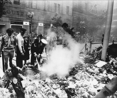 A fire extinguisher and scout’s hats are used to extinguish the smoke bomb. 