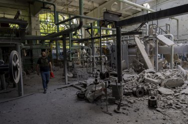 A man inspects the damage of a destroyed boiler room in Kharkiv, eastern Ukraine.