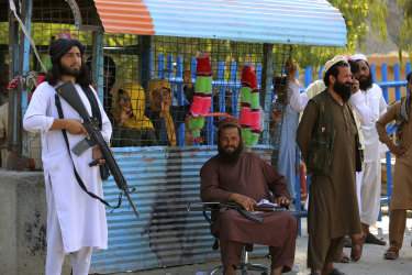 Taliban fighters stand guard on their side at a border crossing point between Pakistan and Afghanistan.