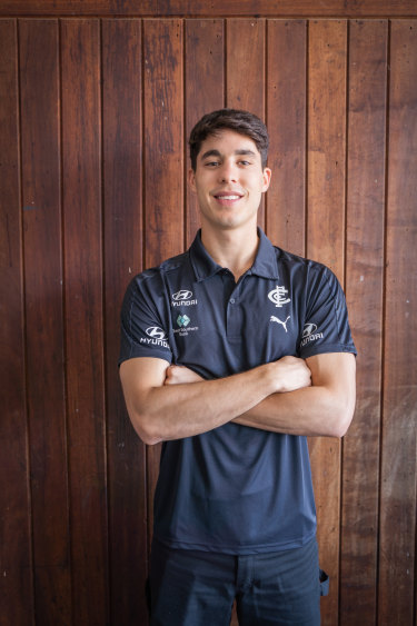 New Carlton midfielder Adam Cerra puts on his navy blue polo after Thursdayâ€™s trade.