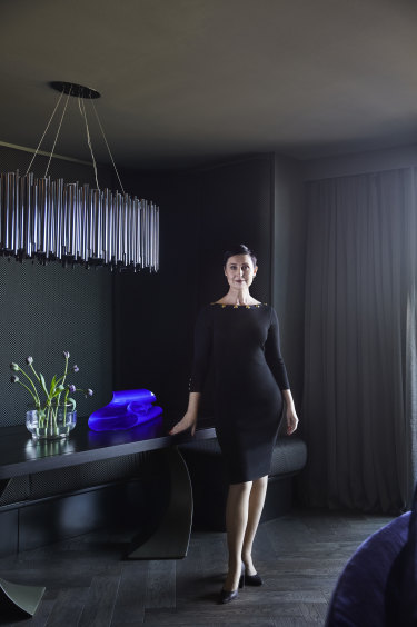 An abundance of custom designs and dark wallpapers create a sense of luxury and drama. The acrylic sculpture on the dining table is by Anya Pesce.