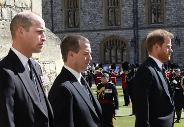 Prince William, Peter Phillips and Prince Harry walk in a procession behind the coffin of Prince Philip.