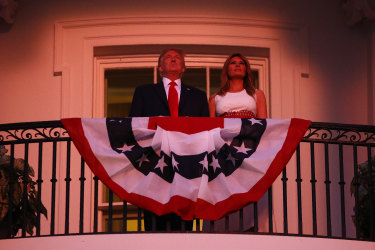 President Donald Trump and first lady Melania Trump stand on the Truman Balcony of the White House as they watch a fireworks display during a "Salute to America" event on July 4.