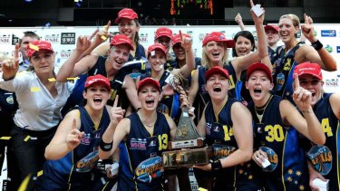 Canberra Capitals players celebrate winning the 2008-09 WNBL title.