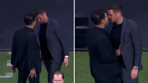Atletico Madrid manager Diego Simeone squares up to Sebastian Kehl on the sidelines.