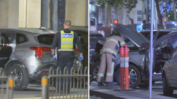 A woman has been arrested and a man is on the run after two allegedly stolen cars crashed on tram tracks in Melbourne's CBD.