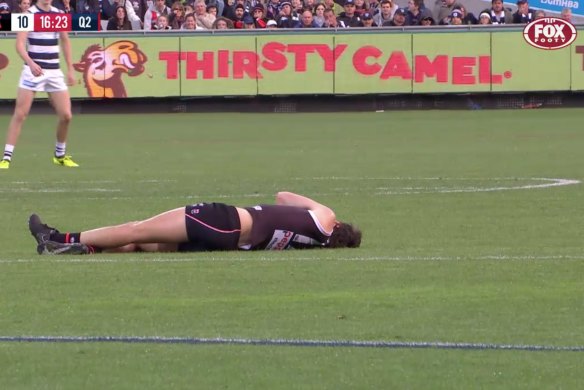 Roberton lies on the ground after collapsing. 