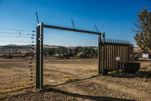 A large security fence surrounds the Muller's property. 