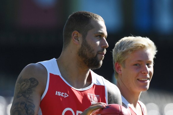 Mentor: Injured Lance Franklin is helping Ronke off the field.